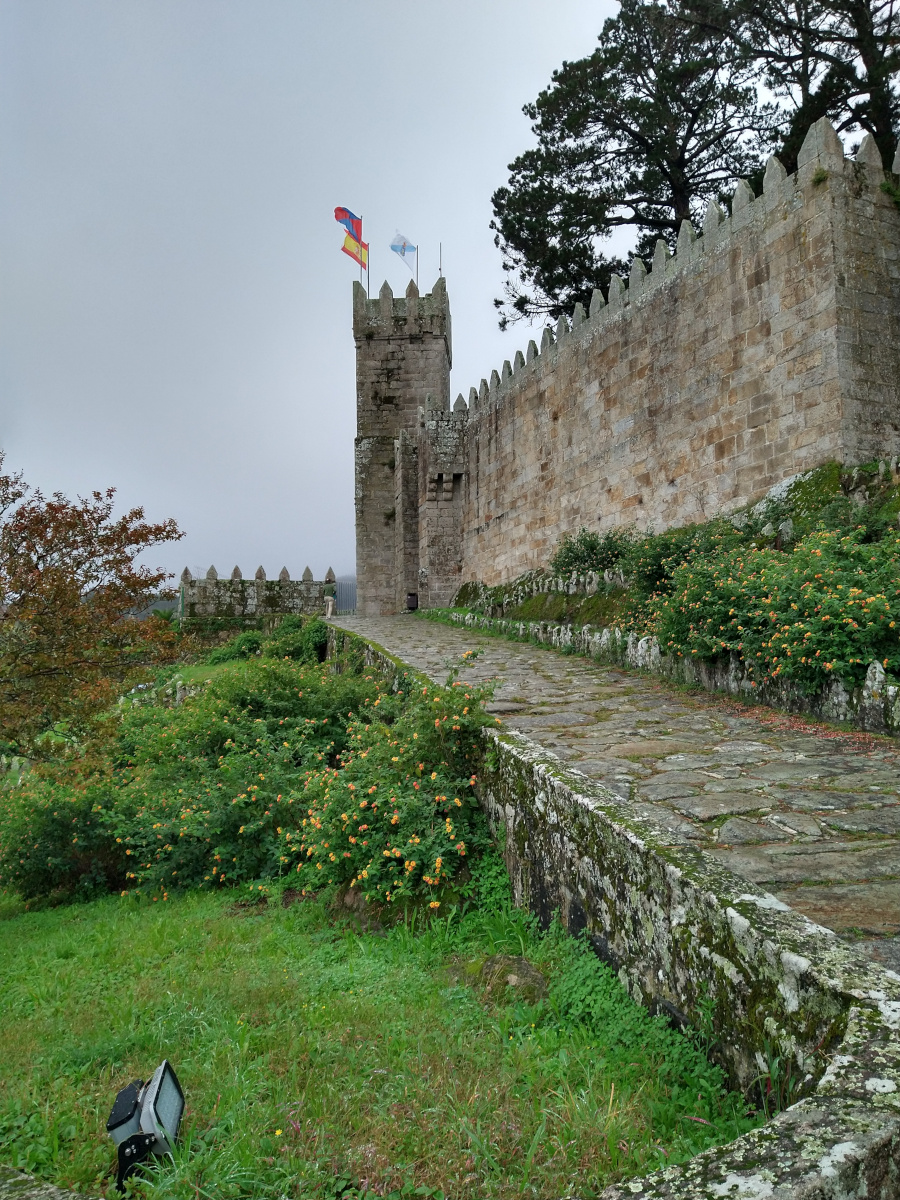 Historic stone fortress with square tower.