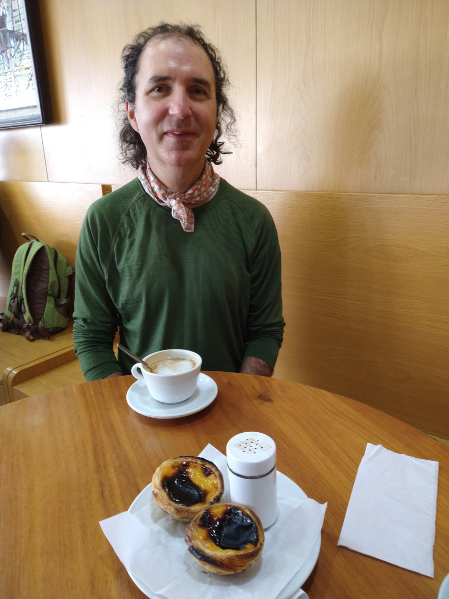 Man enjoying coffee and custard tart.