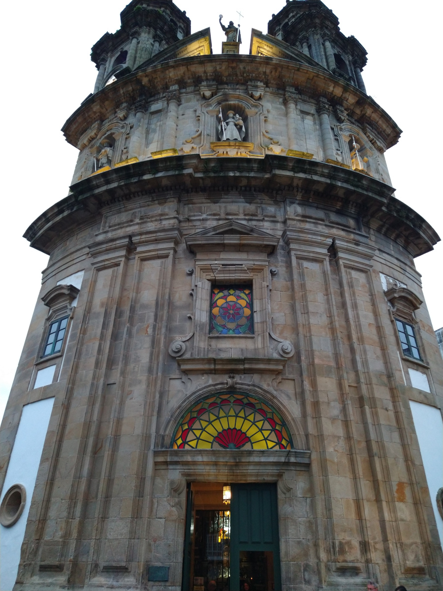 Curved facade of a stone church.
