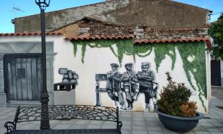 Mural of old men sitting on bench.